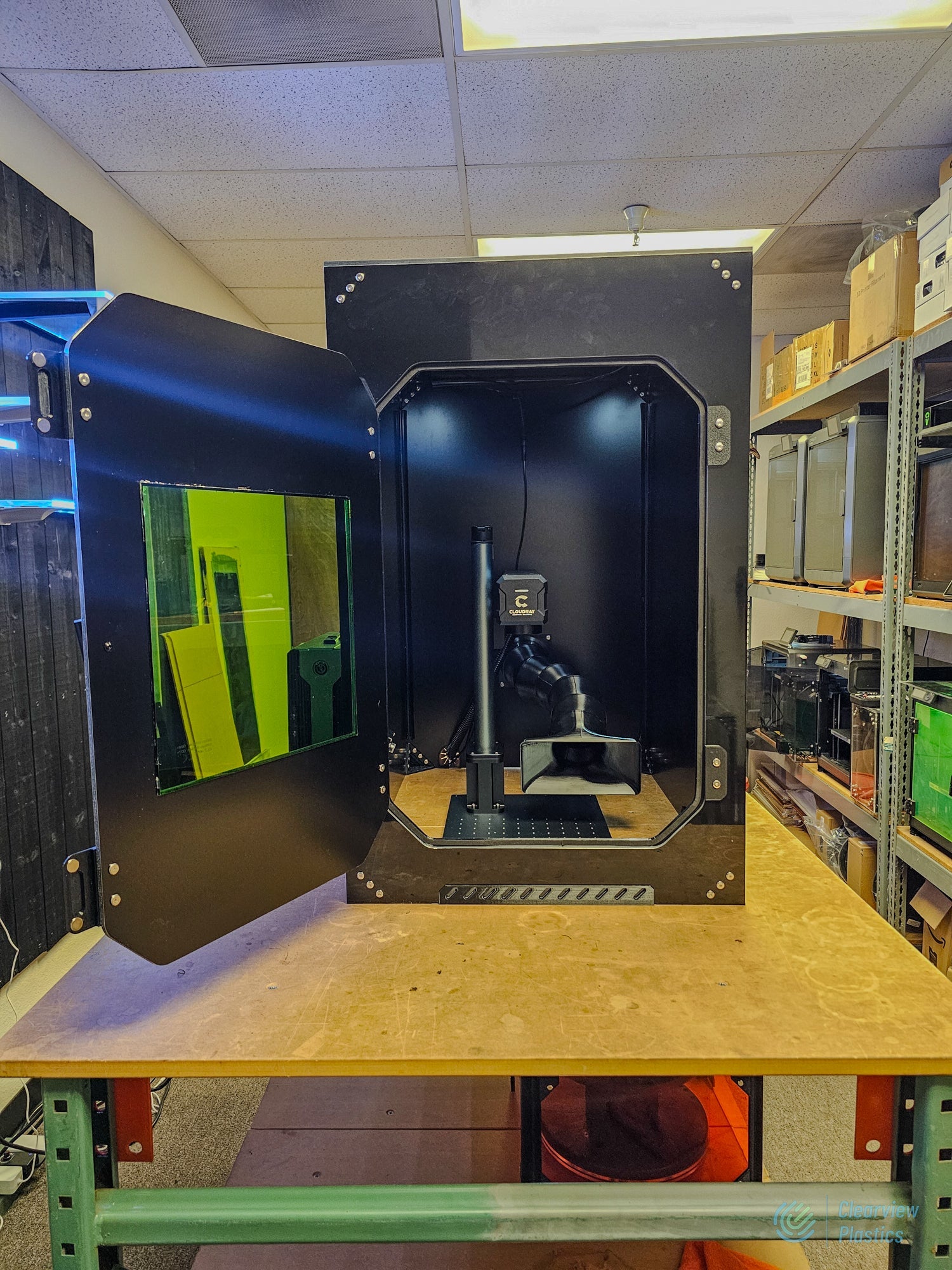 Reference build: Clearview ACM marking enclosure with door open showing laser-safety viewing window and interior