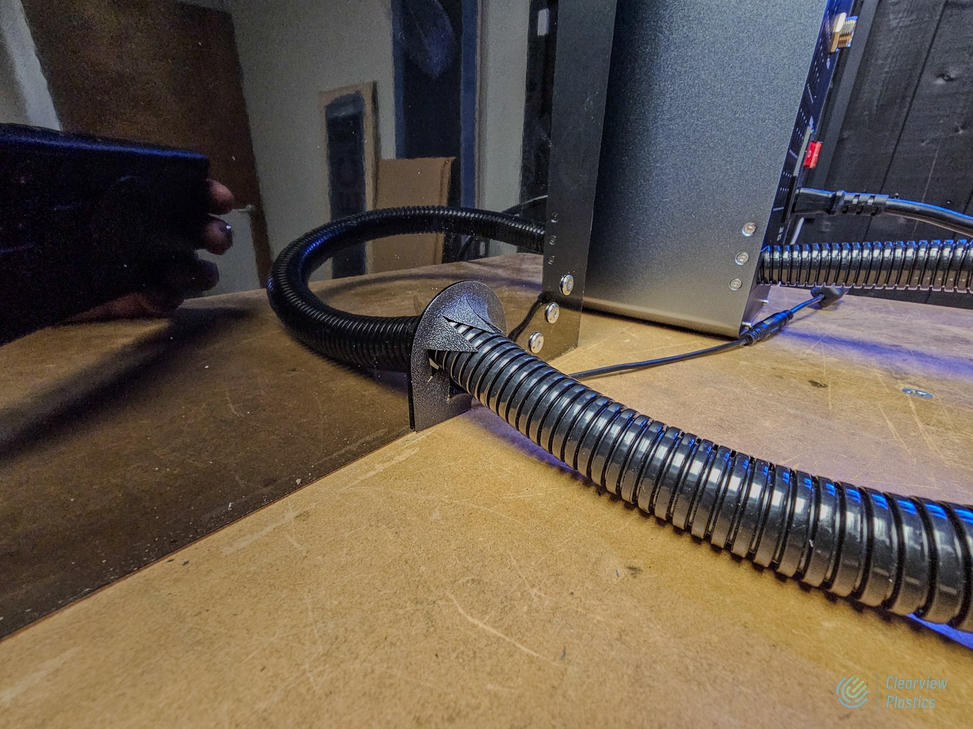 Reference build: sealed cable and exhaust hose pass-through on a Clearview ACM laser enclosure